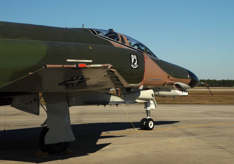GD DSC_4304.JPG - QF-4E, serial # 71-0237, wears markings for the Commander of the 82nd Aerial Targets Squadron (ATRS) along with a high-gloss Southeast Asia paint scheme from the Vietnam-era. Two F-22A Raptors can be seen in the background. This aircraft is configured as a drone but often attends airshows as part of the USAF's popular 'Heritage Flight' program. Heritage Flight puts important aircraft types in formation together to show the USAF lineage and combat heritage. The F-4 Phantom is an important part of any Heritage Flight display. QF-4E Drones are assigned to the 82nd ATRS, 53rd Weapons Evaluation Group (WEG) and fall under the USAF's warfighting command--Air Combat Command.  Photographed on 17 Nov. 2008.  © 2008 Greg L. Davis, Aviation Photojournalist  www.focalplaneimagery.com
